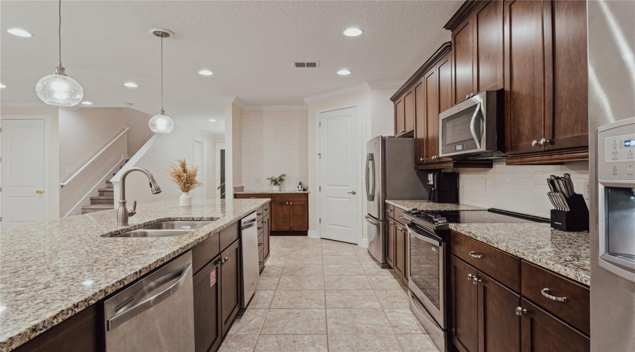 Open Concept Kitchen With Stainless Steel Appliances, 2 Refrigerators And Dishwashers, And Granite Countertops