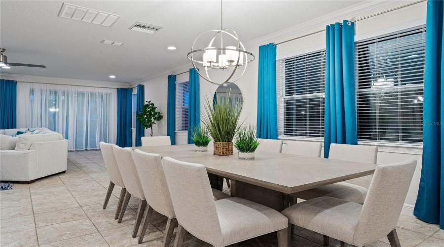 Open Concept Dining Kitchen And Living  Area With Teal Accents