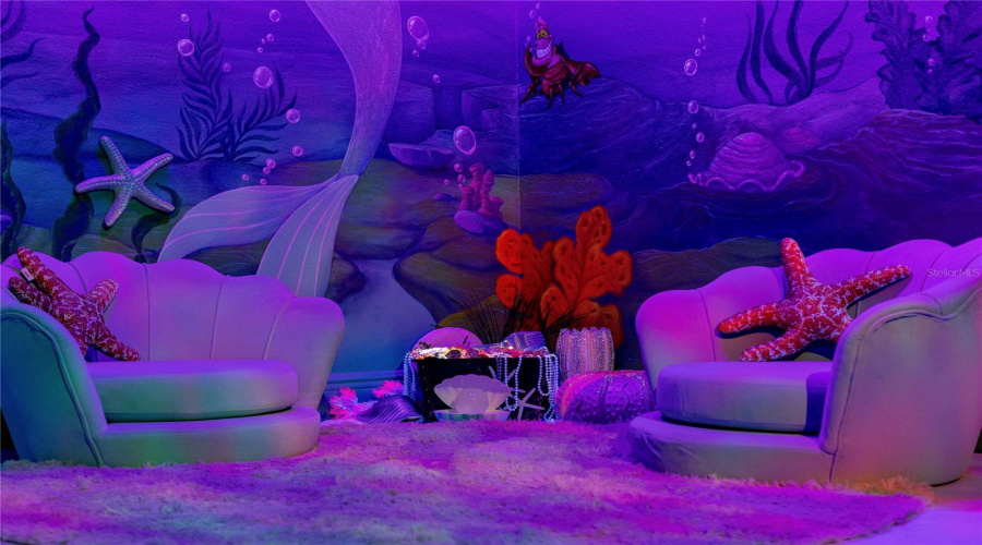 Little Mermaid Themed Bedroom With Seashell Seating, Hand Crafted Treasure Chest, And Custom Black Light Reactive Mural With 3D Accents