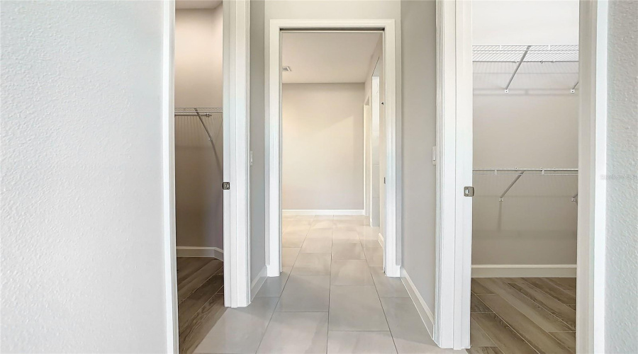 Twin Closets On Either Side Of The Small Corridor Between Primary Bedroom And Ensuite Bathroom