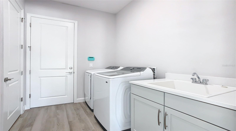 Laundry Room Provides Access To Garage