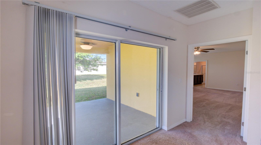 Sliding Door To The Backyard/Entrance To Primary Bedroom