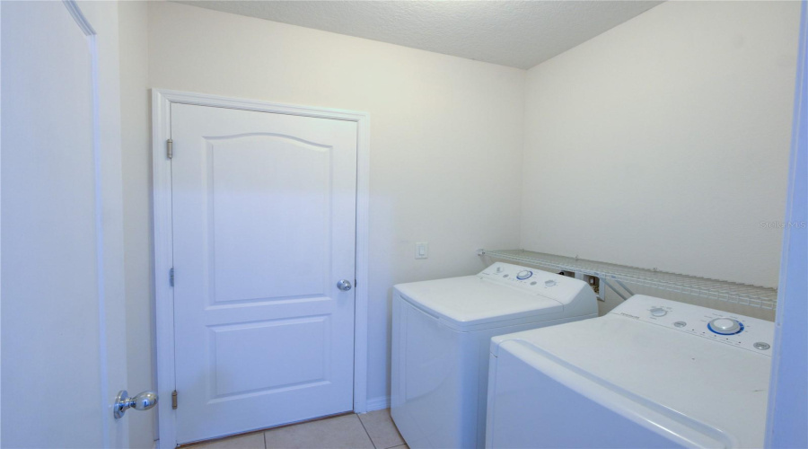 Washer And Dryer Room, Entrance To The Garage