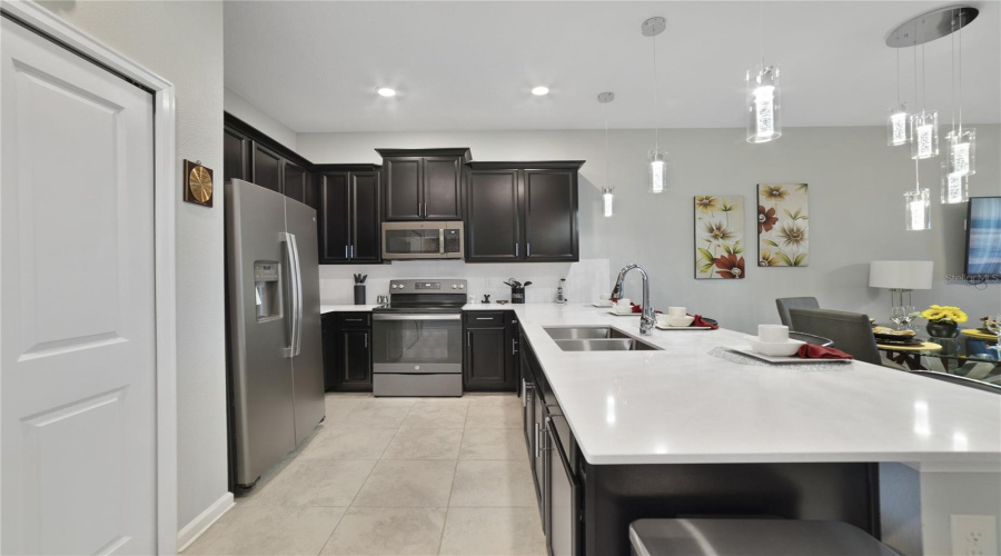 The Family Chef Will Appreciate The Rich Cabinetry, Stainless Steel Appliances, Closet Pantry For Ample Storage And A Breakfast Bar For Casual Dining Or Entertaining!