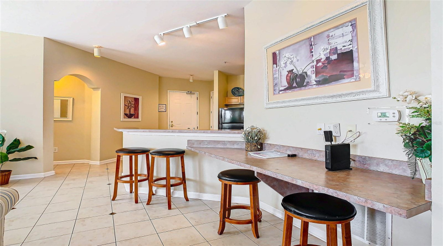 There Is An Extended Breakfast Bar Or Work Station That Extends Into The Living And Dining Area.
