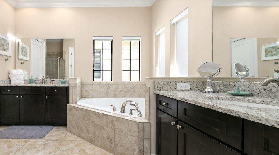 Upper Level Primary Bathroom With Soaking Tub And Separate Vanities