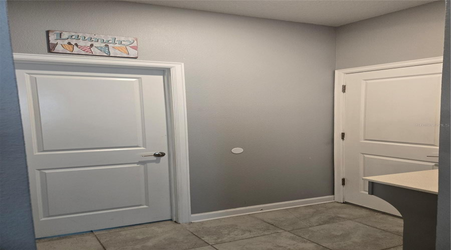 Service Area To The Laundry Room And Garage Entrance