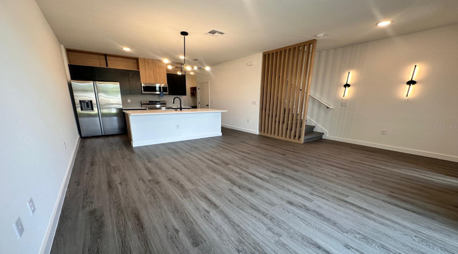 Upgraded Cabinetry And Lighting, Quartz Countertops, And Wooden Slats