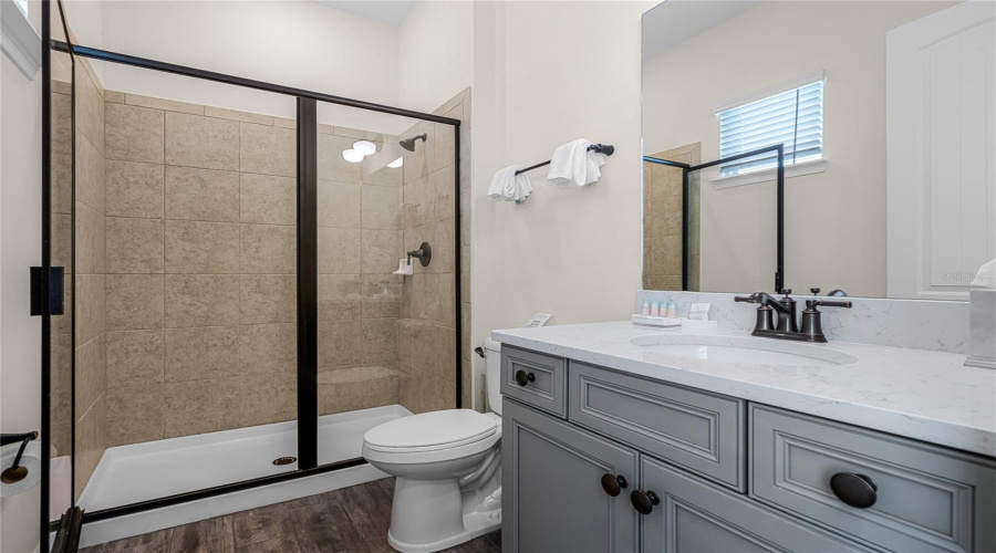 Second Bathroom With Single Sink Vanity Area, And An Glass Enclosed Standing Shower