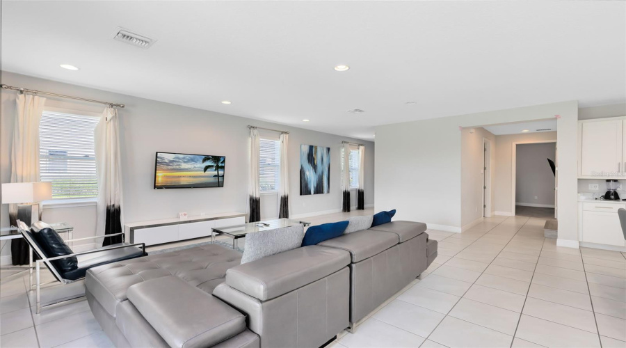 The kitchen is open to the spacious living room with sliders that open to the luxury paves and heated private pool/spa oasis, great for relaxing and entertaining.