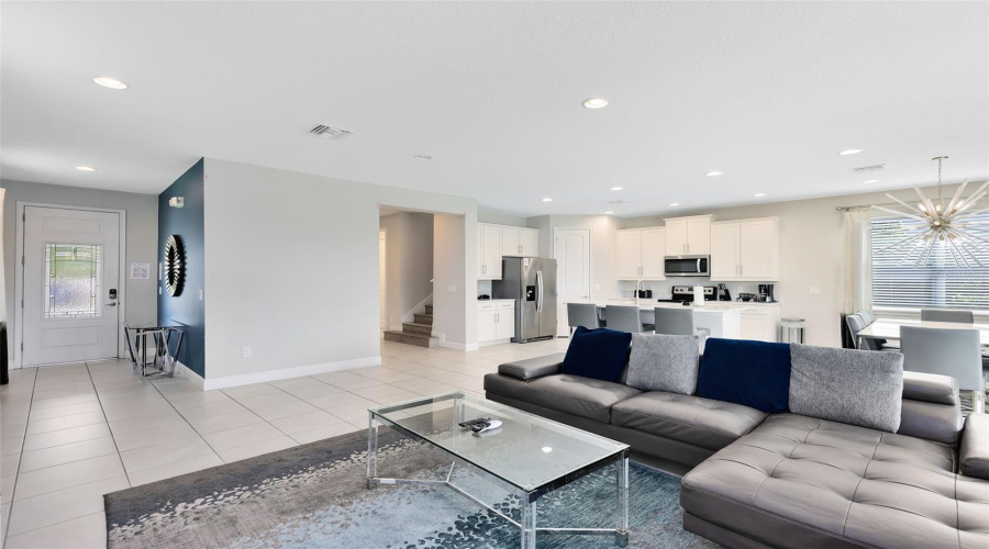 The kitchen is open to the spacious living room with sliders that open to the luxury paves and heated private pool/spa oasis, great for relaxing and entertaining.
