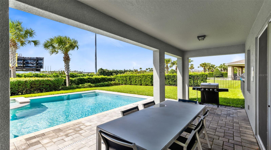 Paved and heated private pool/spa oasis with a covered paved patio and grill, great for relaxing and entertaining.