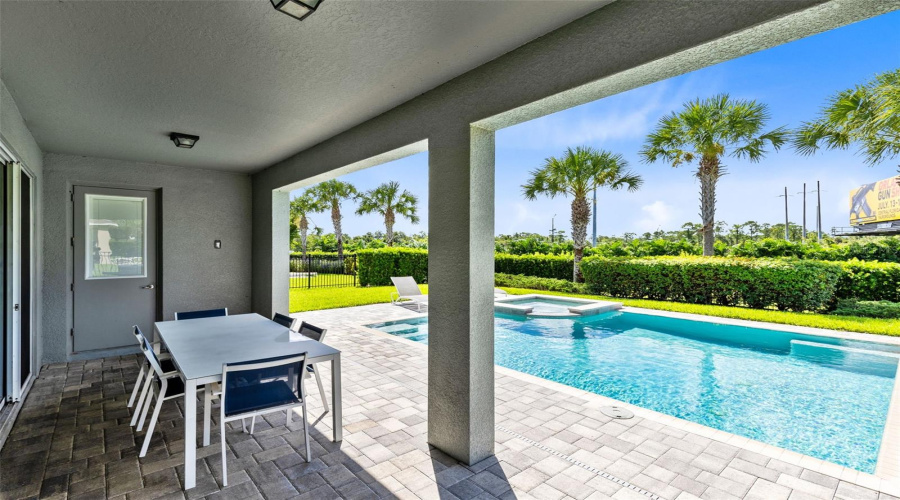 Paved and heated private pool/spa oasis with a covered paved patio and grill, great for relaxing and entertaining.