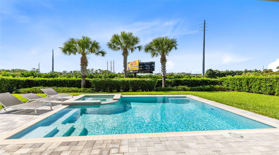 Paved and heated private pool/spa oasis with a covered paved patio and grill, great for relaxing and entertaining.