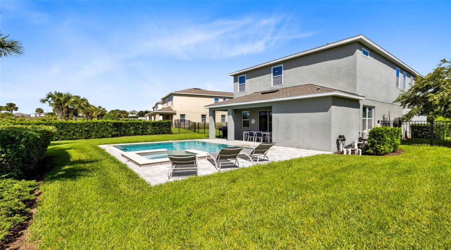 Paved and heated private pool/spa oasis with a covered paved patio and grill, great for relaxing and entertaining.