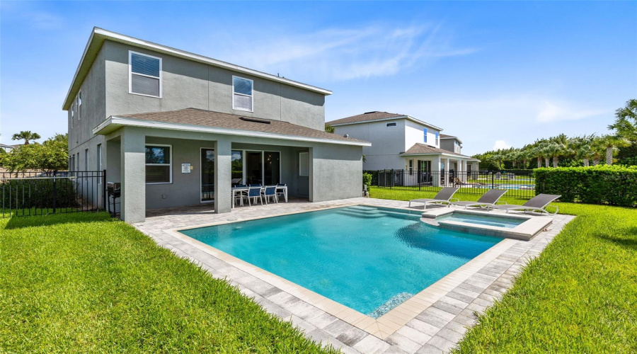 Paved and heated private pool/spa oasis with a covered paved patio and grill, great for relaxing and entertaining.