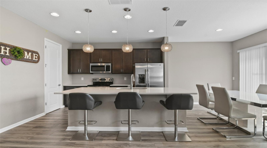 The Family Chef Can Stay Connected While Entertaining Friends And Family Over Bar Seating At The Large Island, There Is Recessed As Well As Pendant Lighting, Stainless Steel Appliances, Stylish Cabinetry And Plenty Of Storage.