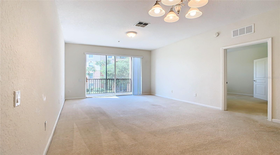 The Dining/Living Room Opens Up To The Sliding Glass Doors Looking Out To The Coutyard And Pond.