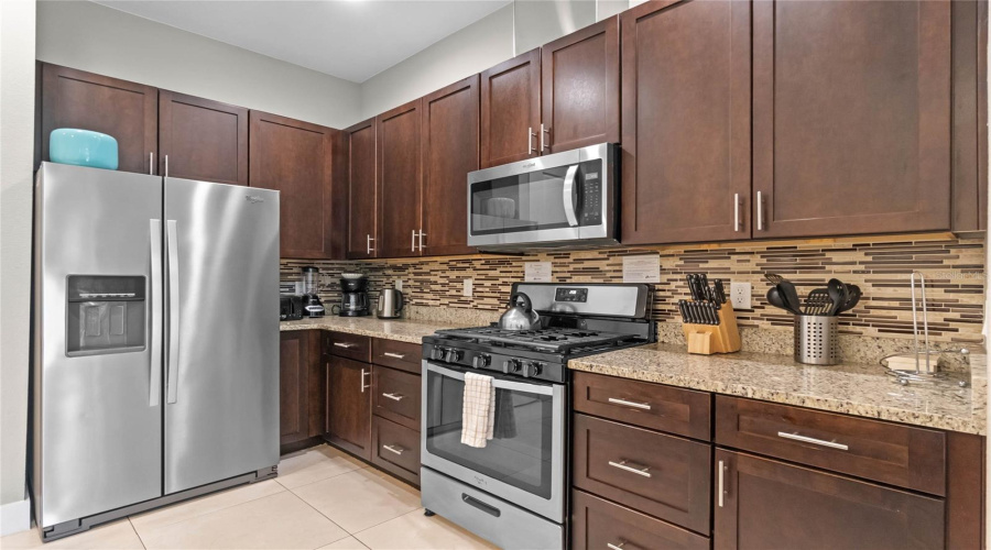 Kitchen Features Stainless Steel Appliances Including A Gas Range