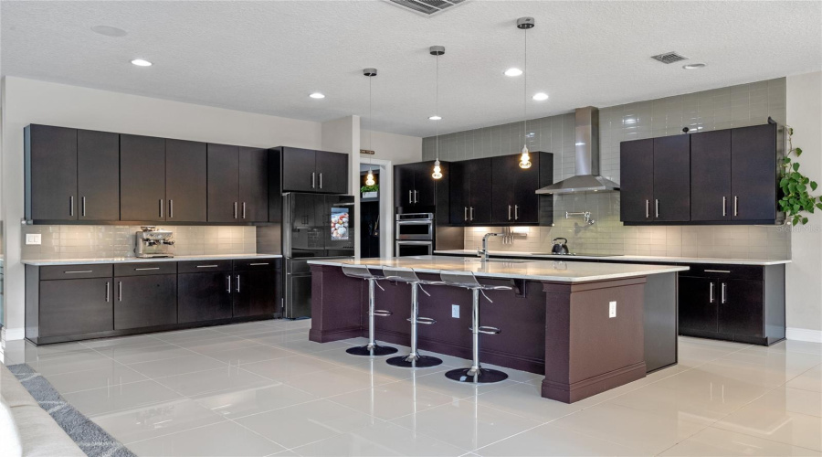 The Kitchen Features A Large Center Island With Eat In Space, Upgraded Kitchenaid Stainless Steel Appliances, 48