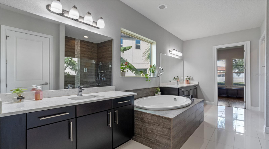 The Primary Bathroom Features Double Vanities, Garden Tub, Walk In Shower And Adjacent Walk In Closet.