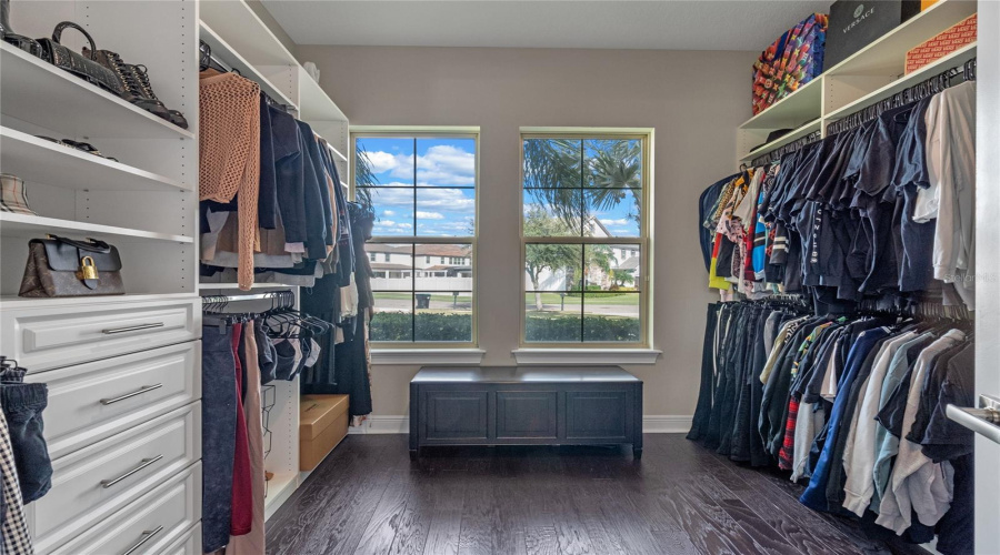 The Primary Bedroom Closet Features Custom Built In Cabinetry