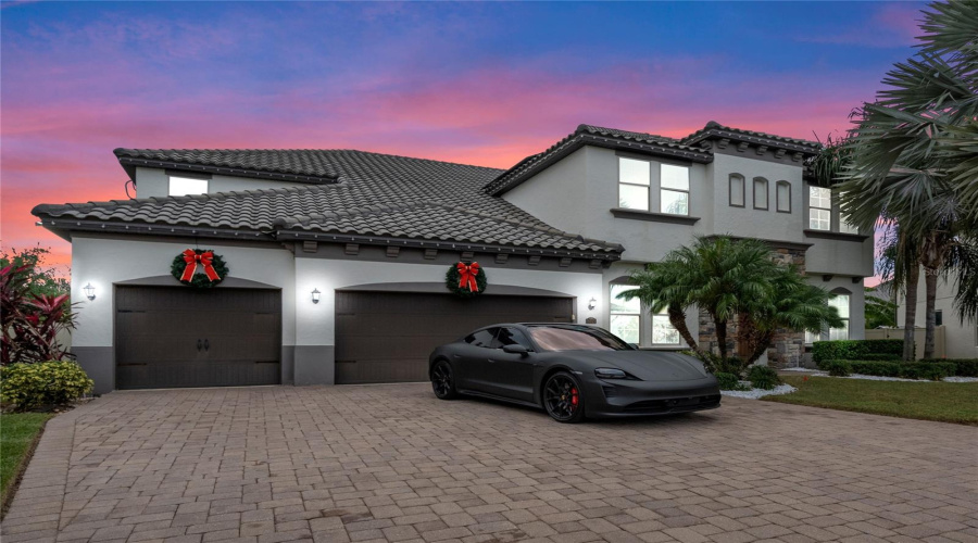 This Home Features A Four Car Garage With Ev Charger, Paver Driveway And Mature Landscaping.