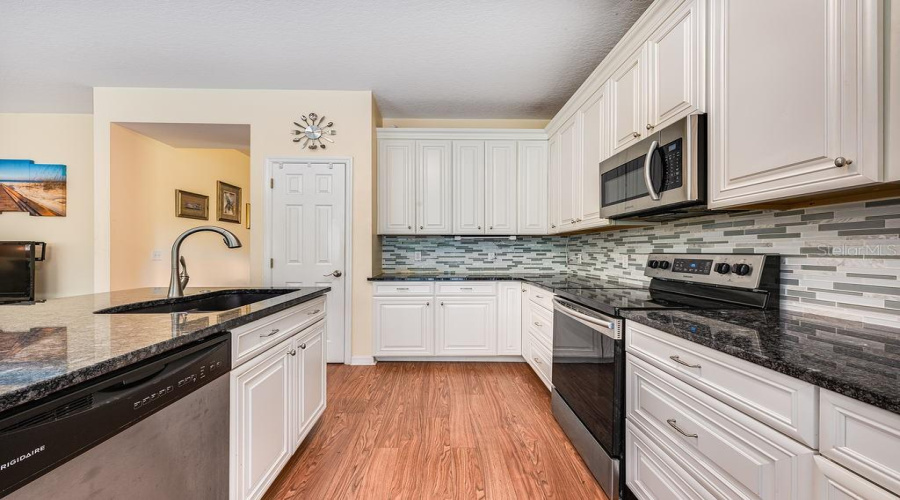 The Home Chef Will Delight In The Upgraded Kitchen Delivering A Fresh Modern Color Palette, Stainless Steel Appliances, Tiled Backsplash, Breakfast Bar Seating On The Island And The Pantry Provides Ample Storage.