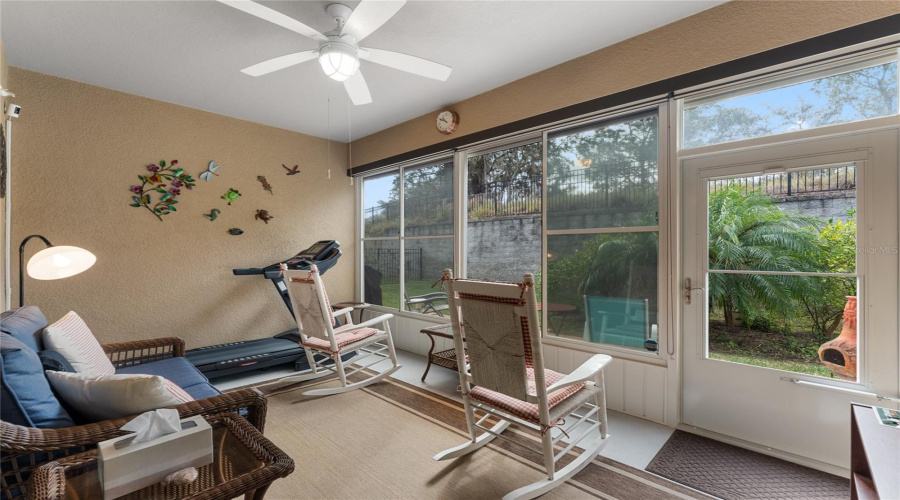 Enclosed Lanai With Retractable Awning That Also Covers The Papered Patio