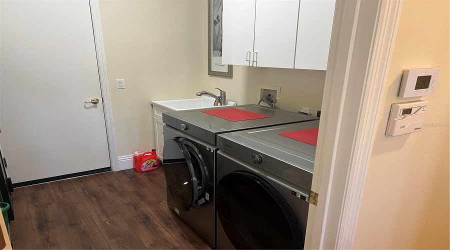 Laundry Room With Sink And Entrance To Garage