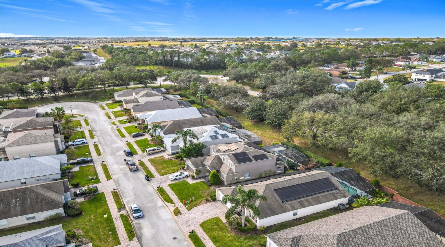 An Aerial View Showing Sidewalks In The Front And A Treelined Street In The Back.