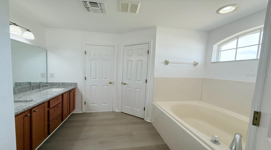 Large Garden Tub In Primary Bath With Walk-In Shower And Separate Water Closet.