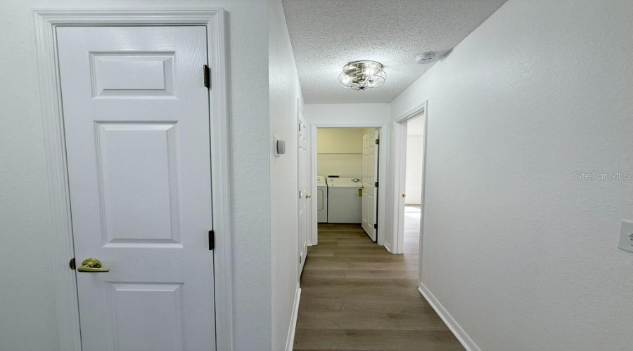 Hallway To Laundry And Primary Bedroom.