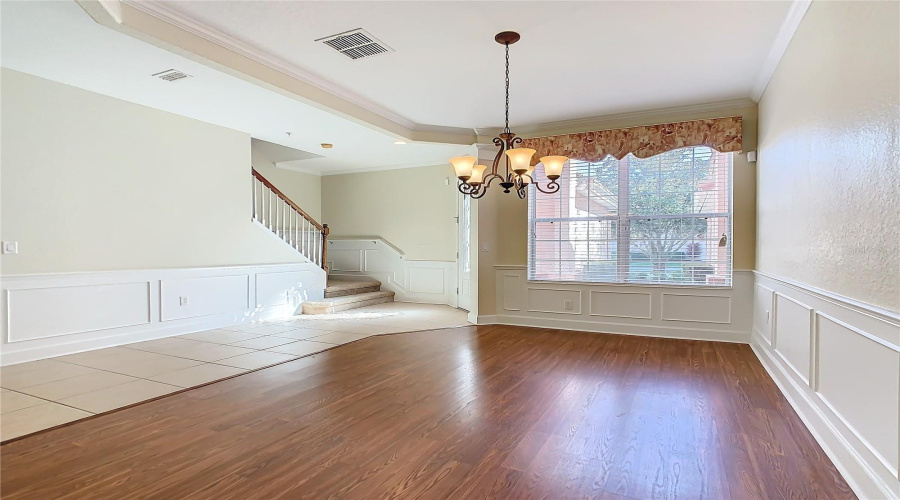 Looking toward the front of the home seeing the entry, staircase, and dining room.