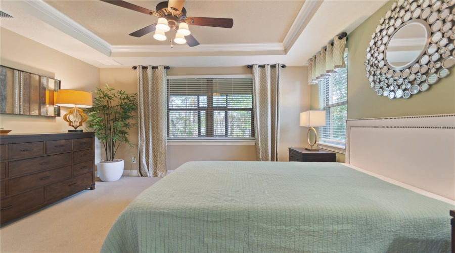 Primary Bedroom with nature views of backyard
