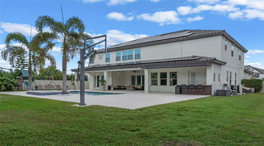 Expansive Backyard With View Of Half Court Basketball Area And Summer Kitchen