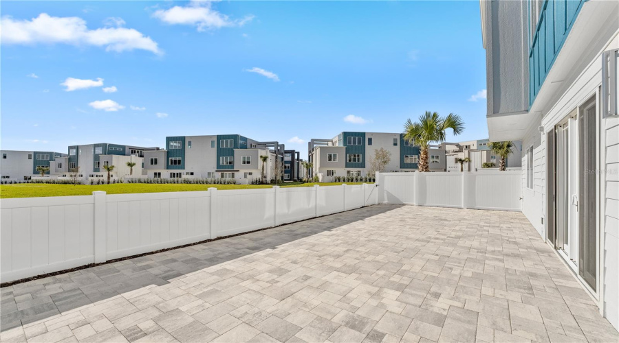 Paved and fenced patio area.