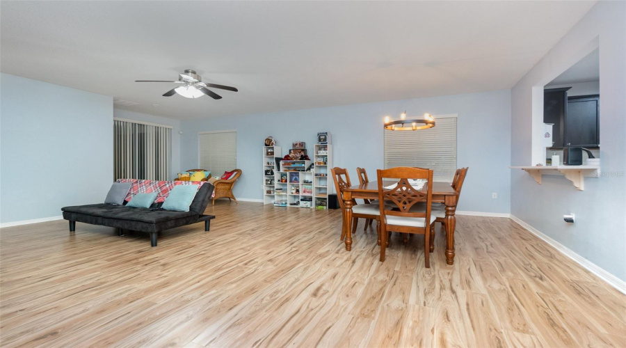 Spacious Great Room With Combined Dining Room/Living Room With Laminate Flooring And Ceiling Fan.