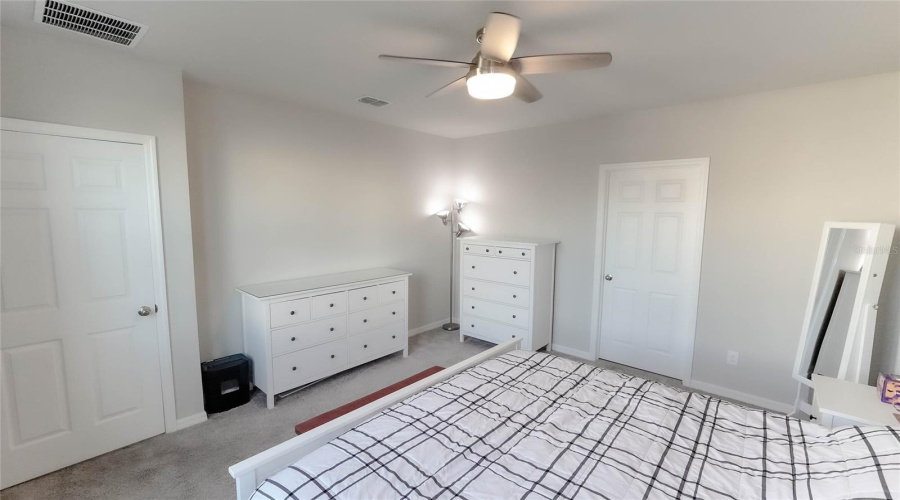 Another View Of The First Floor Primary Bedroom.  Door On The Left Leads To The Open Concept Main Living Areas.  Door On The Right Leads To The Ensuite Bath And Walk-In-Closet Areas.