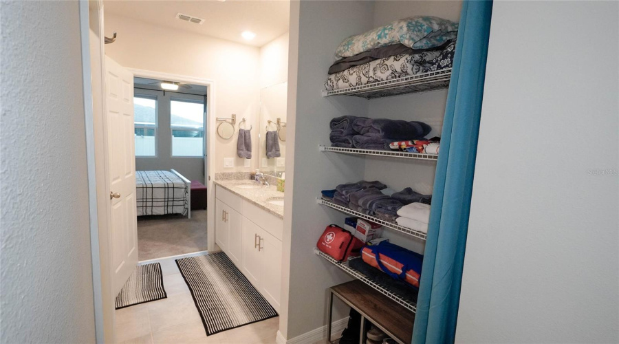 View From The Ensuite Bath Into The Primary Bedroom Showcasing The Extra Large Linen Closet.