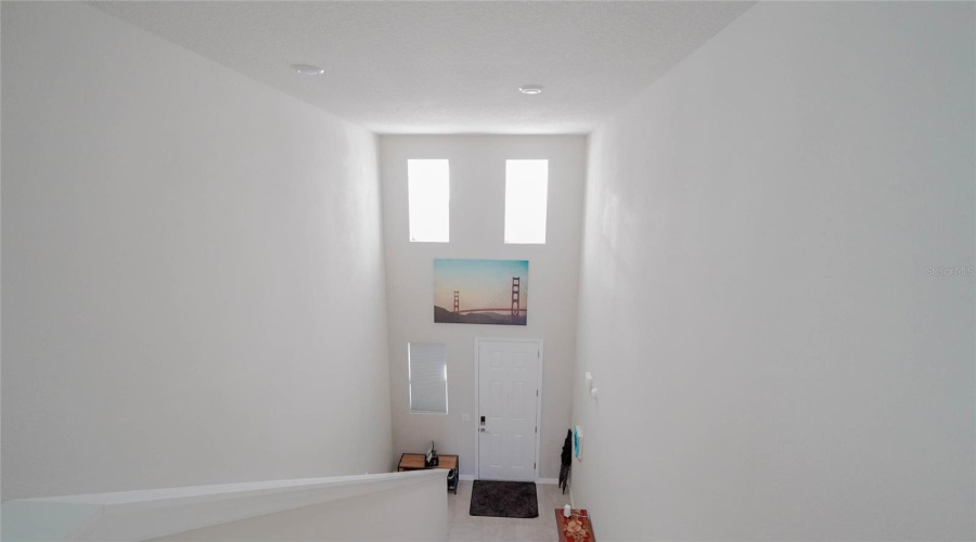 Looking Down On The Front Entry / Foyer From The Second Story Loft Area.  The High Ceilings Are A Wonderful Feature!