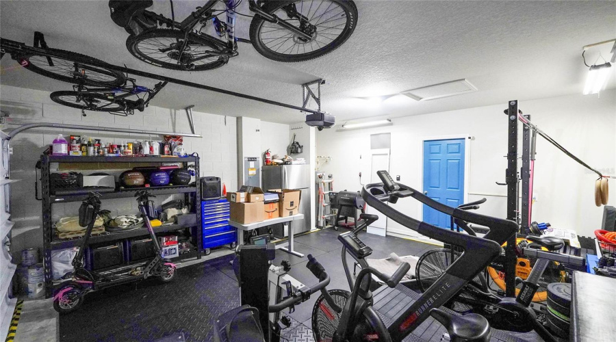 Another Shot Of The Two-Car Garage Area.  The Blue Door Is The Entrance Into The Laundry Area And House.