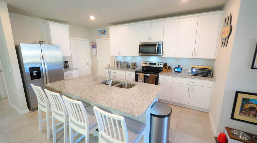 The Kitchen Features A Large Island With Eating Area, Granite Countertops, 42