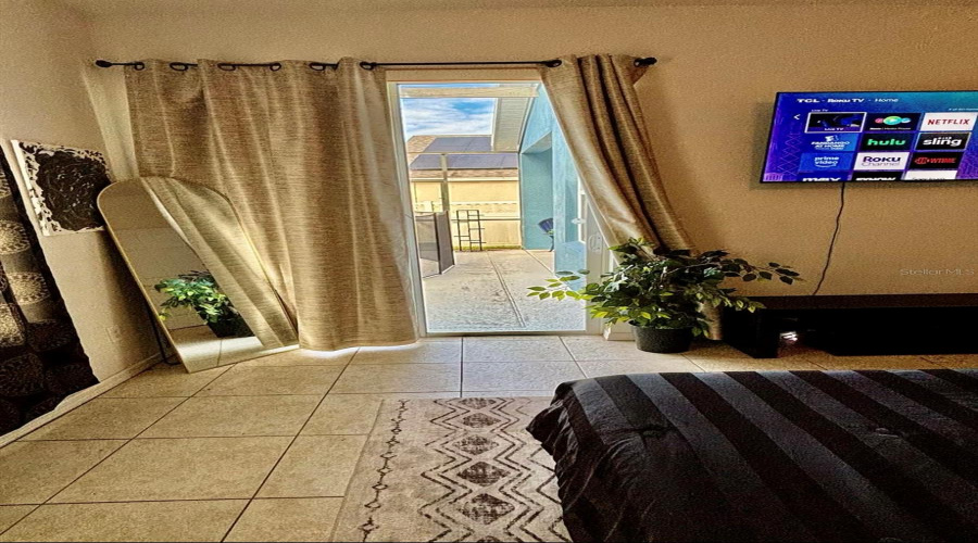The primary bedroom boasts sliding doors leading directly to the pool area.