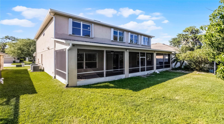Covered and screen-enclosed rear patio stretches the width of the home