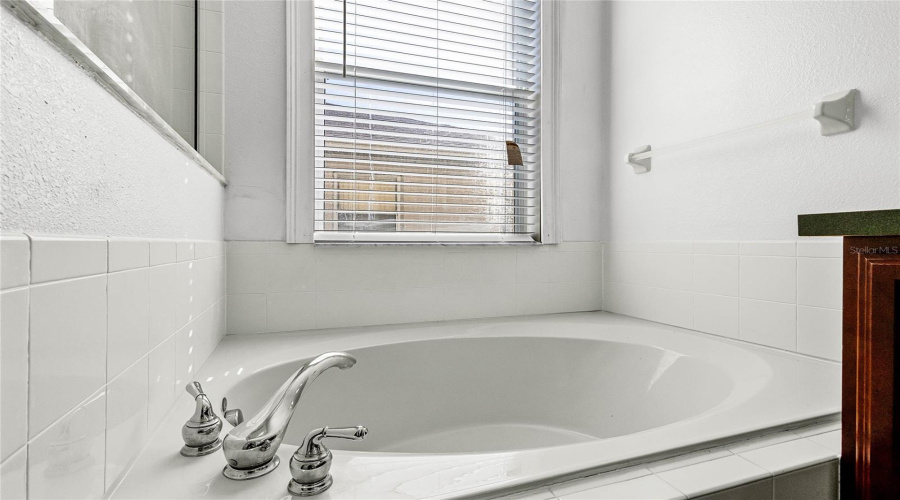 Soaking tub in primary bathroom, 1st floor