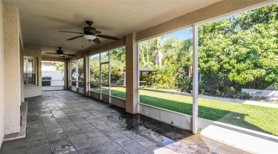 Rear covered & screen-enclosed patio, looking into back yard