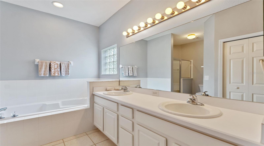Private Bathroom With Linen And Walk-In Closets