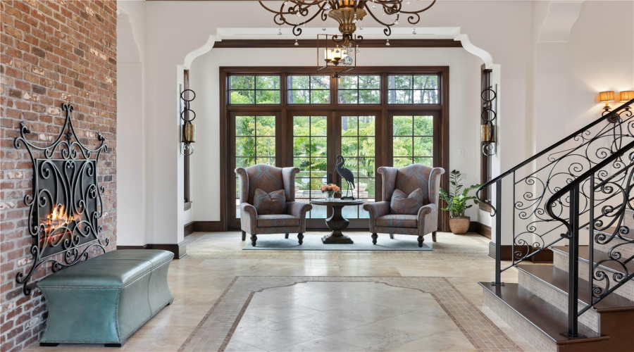 Grand foyer as you enter the home with views of the pool and conservation