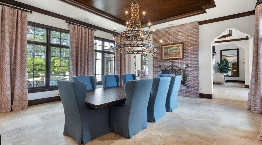 Formal dining room with fireplance and attached wet bar access